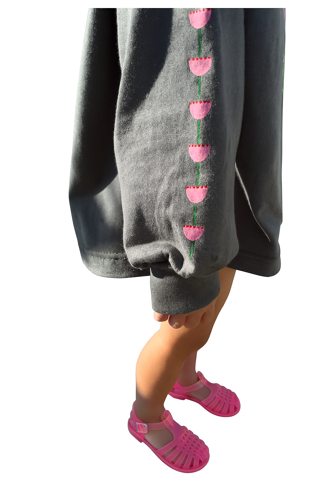 kids long sleeve tshirt featuring a belle sleeve with chunky cuffs detail oversized fit with bold pink green and red flower graphic hand painted logo in white on a charcoal organic cotton tshirt comfortable boxxy fit soft fabric made for playing fun and adventure