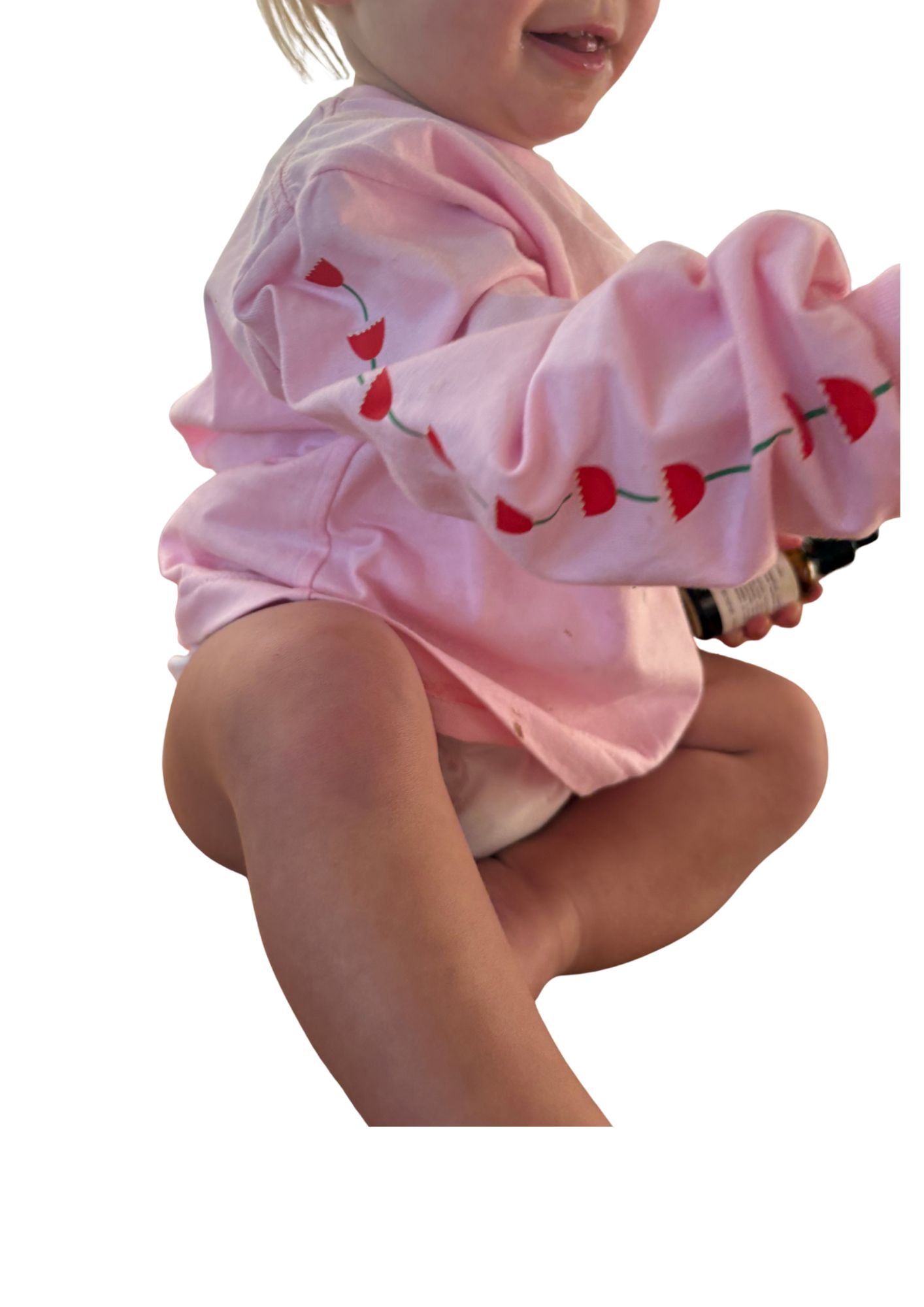 kids long sleeve tshirt featuring a belle sleeve with chunky cuffs detail oversized fit with bold pink green and red flower graphic hand painted logo in white on a baby pink organic cotton tshirt comfortable boxxy fit soft fabric made for playing fun and adventure
