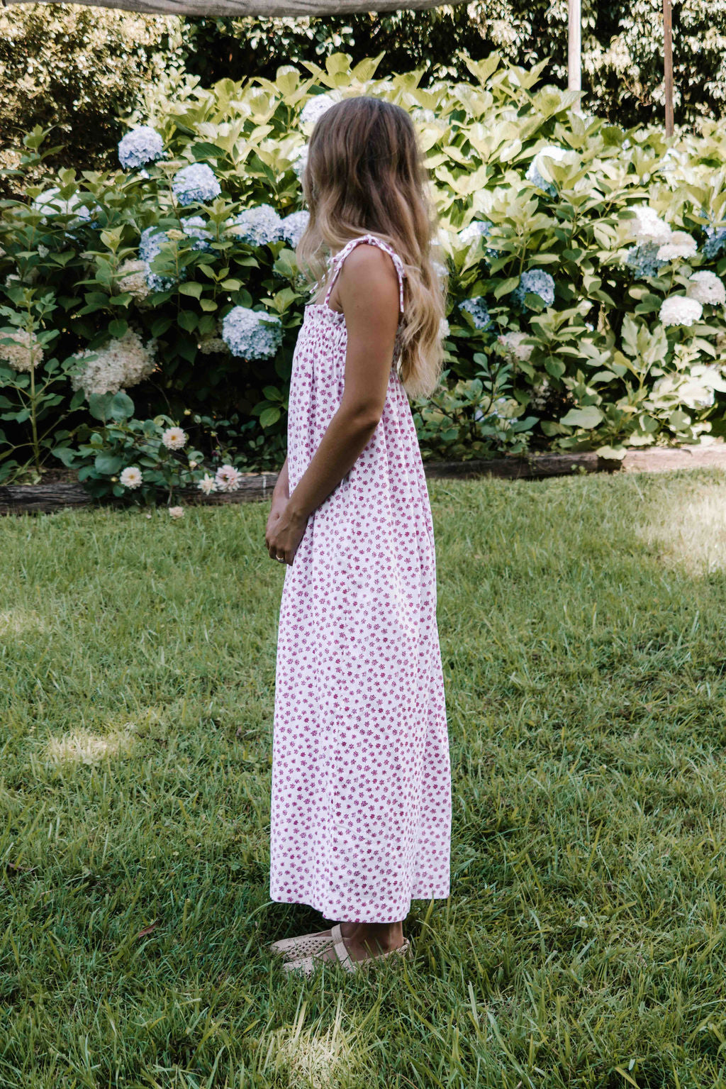womens slip on maxi dress pink magenta flower floral print on a white background rouched tie up top strappy shoulders very flattering fit versatile wear through the seasons