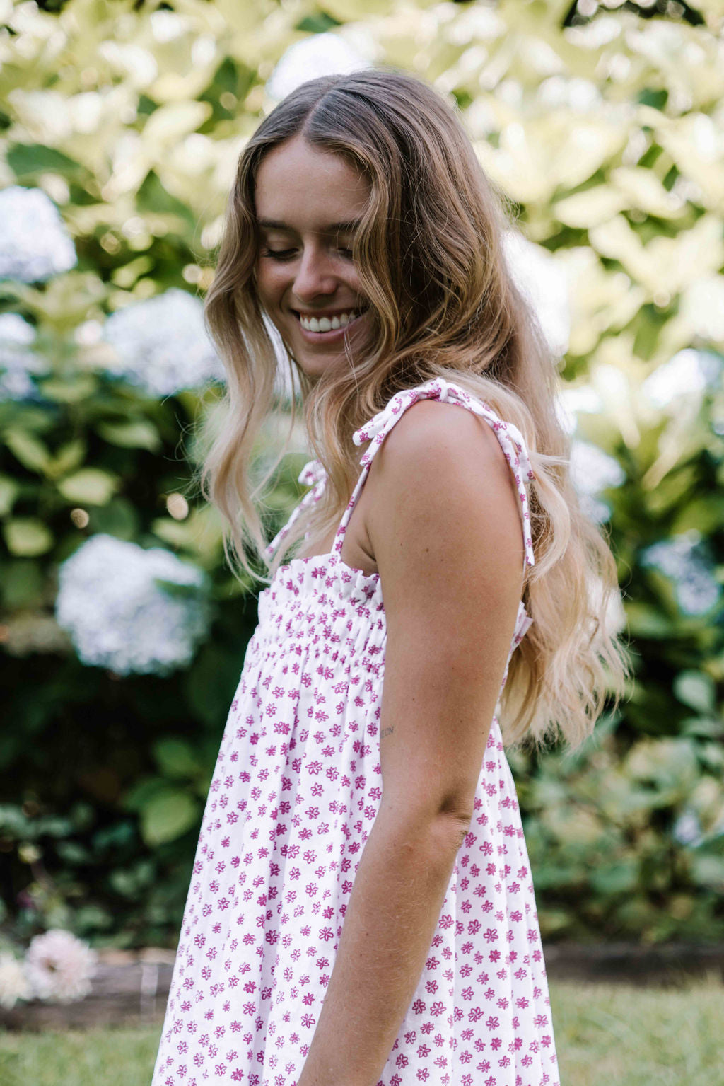 womens slip on maxi dress pink magenta flower floral print on a white background rouched tie up top strappy shoulders very flattering fit versatile wear through the seasons