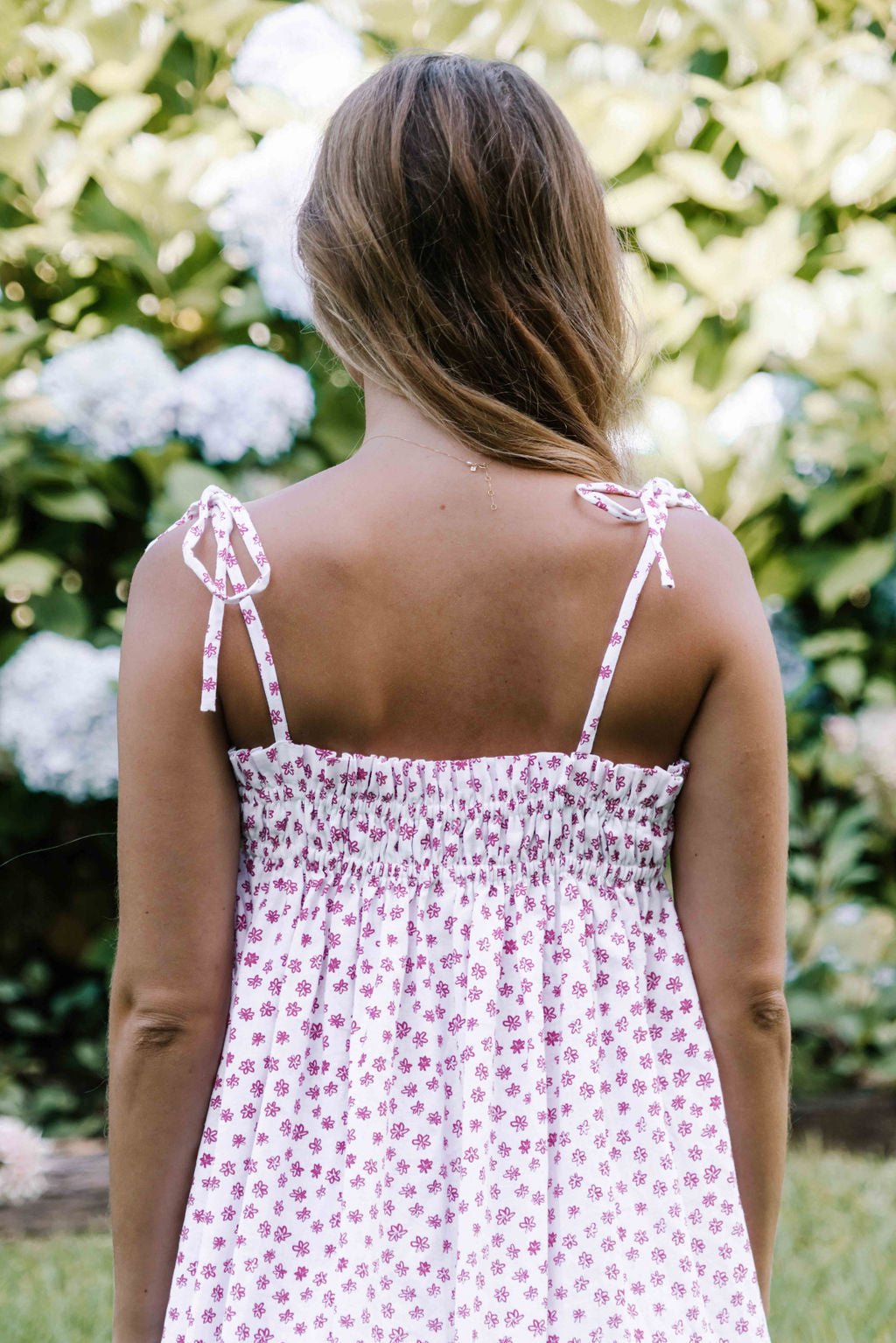 womens slip on maxi dress pink magenta flower floral print on a white background rouched tie up top strappy shoulders very flattering fit versatile wear through the seasons
