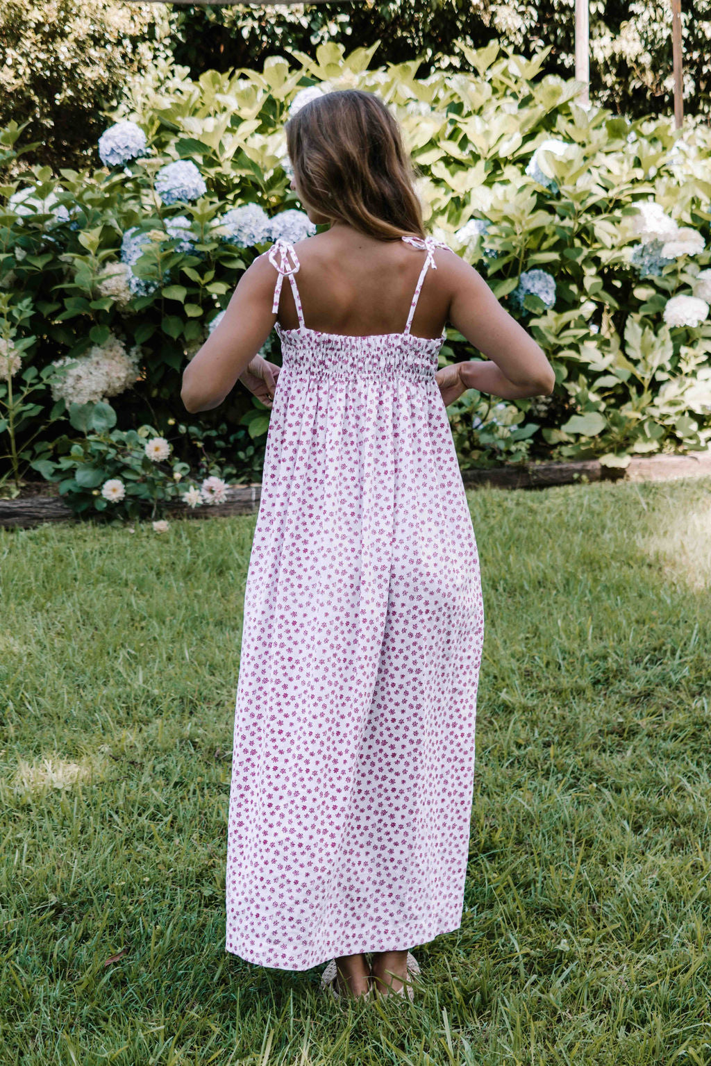 womens slip on maxi dress pink magenta flower floral print on a white background rouched tie up top strappy shoulders very flattering fit versatile wear through the seasons