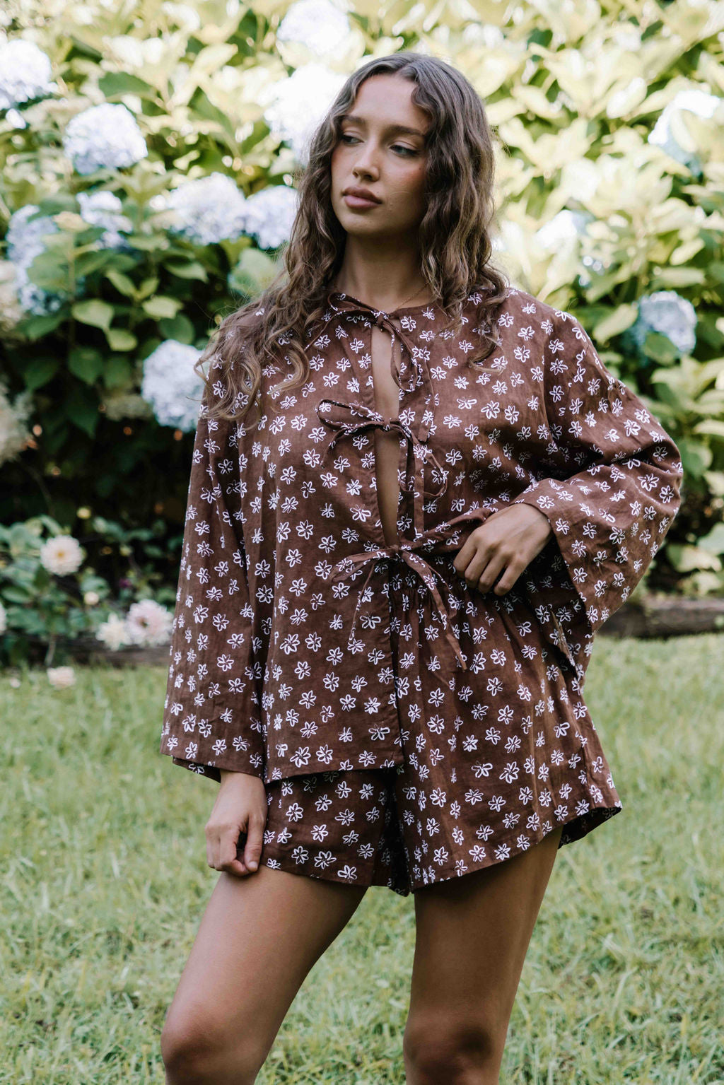 tie front blouse, cotton linen fabric, boxy fit, centre front ties, long sleeves to the wrist, white hand painted flower floral print on dark brown mocha colour, womens top