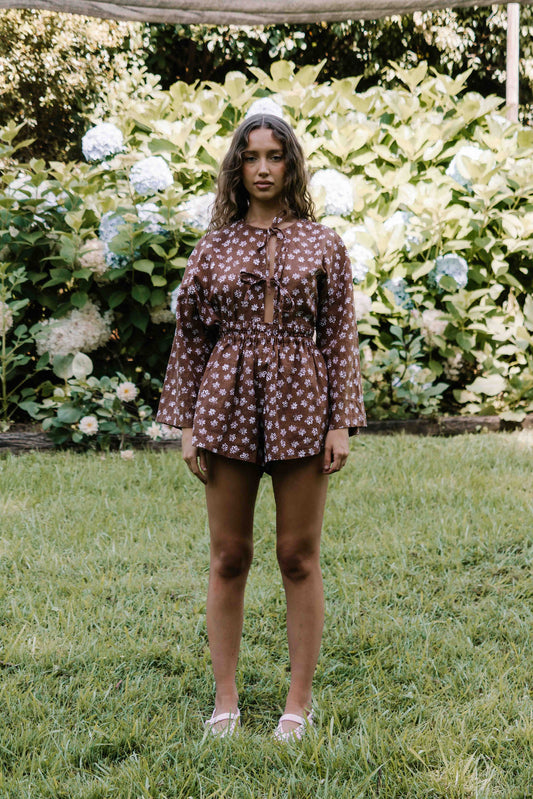 womens shorts with elastic waist and pockets, high waisted but can be worn lower. White HAND PAINTED flower print in dark mocha brown colour.