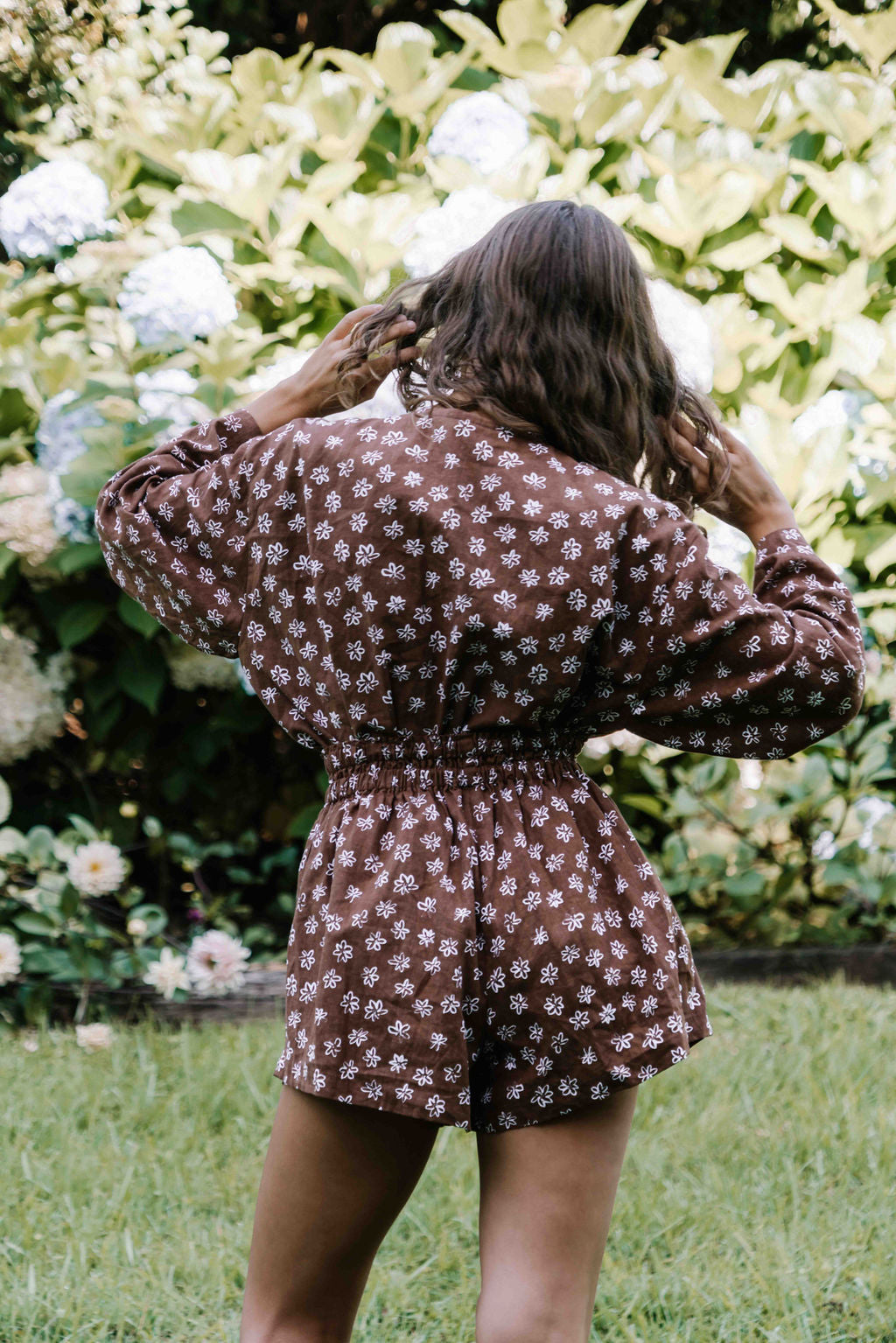 womens shorts with elastic waist and pockets, high waisted but can be worn lower. White HAND PAINTED flower print in dark mocha brown colour.