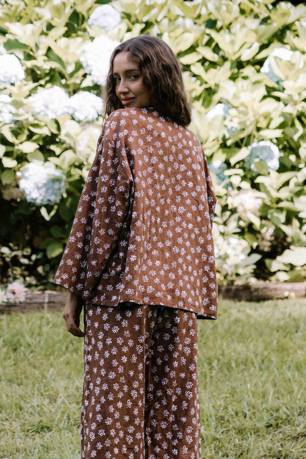 tie front blouse, cotton linen fabric, boxy fit, centre front ties, long sleeves to the wrist, white hand painted flower floral print on dark brown mocha colour, womens top
