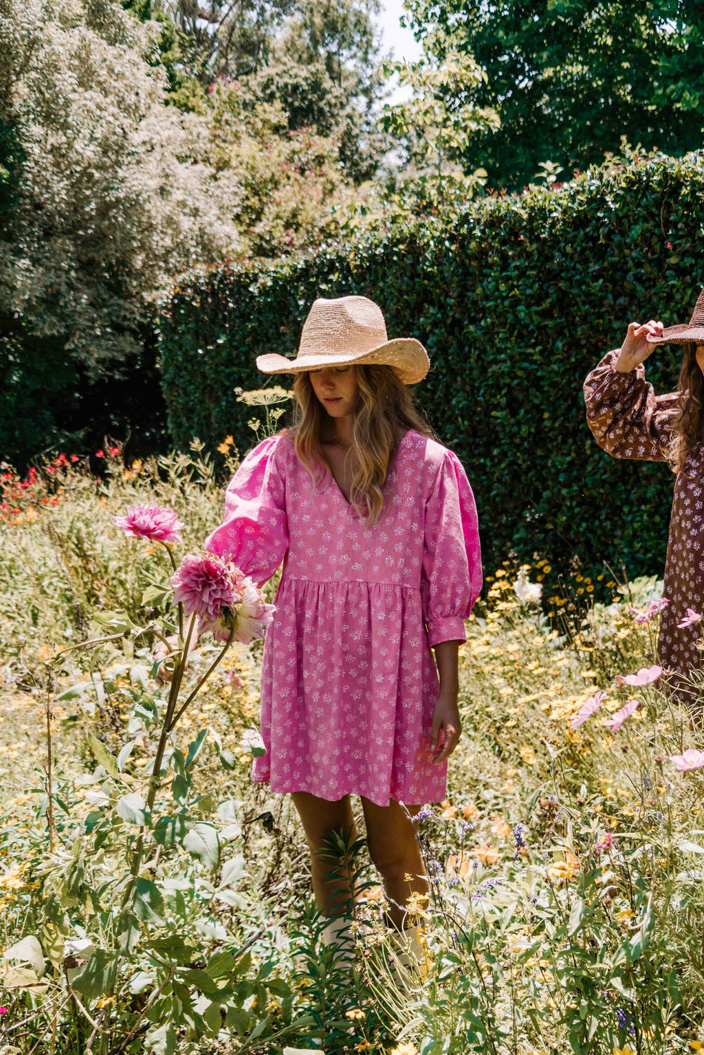womens v neck mini smock made from 100% highest quality cotton linen. A flattering cut with an adjustable back tie. Puffed 3/4 sleeves and a drop waist with a short dress length. Super comfortable dress, adjustable back tie and in a floral flower print in bright candy pink.