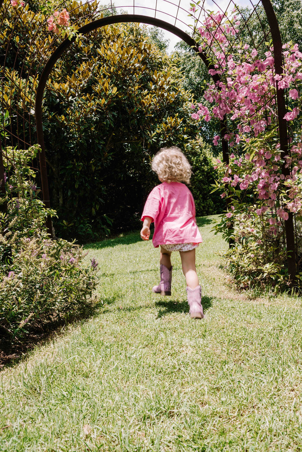 kids tshirt oversized fit with bold graphic hand painted logo in white on a lolly bright pink organic cotton tshirt comfortable boxxy fit soft fabric