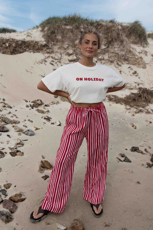 womens wide leg full length relaxed fit pant in a vibrant red and pink cotton linen fabric with a hand painted striped print elastic waist with drawstring wide leg fit to the ankles