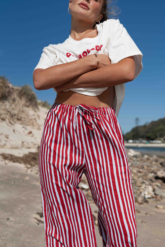 womens wide leg full length relaxed fit pant in a vibrant red and baby blue cotton linen fabric with a hand painted striped print elastic waist with drawstring wide leg fit to the ankles