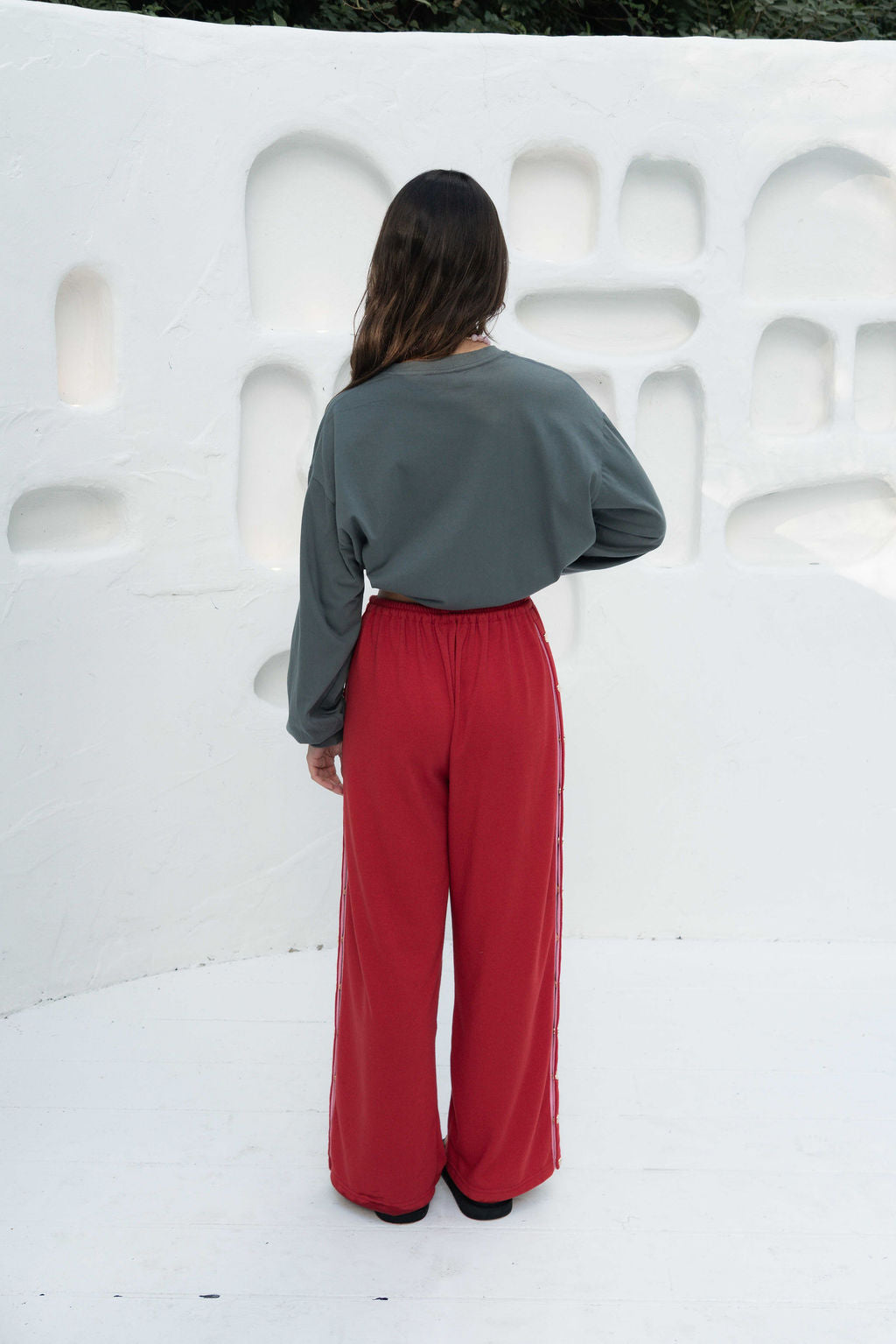 womens wide leg full length relaxed fit pant in a red terry cotton fabric with a pink drawstring and gold heart shape push studs down each leg wide leg fit to the ankle