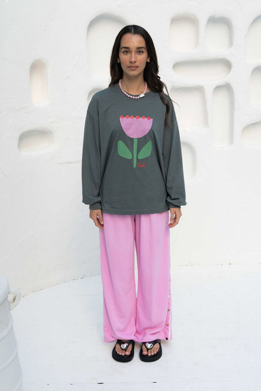 womens wide leg full length relaxed fit pant in a pink terry cotton fabric with a white drawstring and gold heart shape push studs down each leg wide leg fit to the ankle