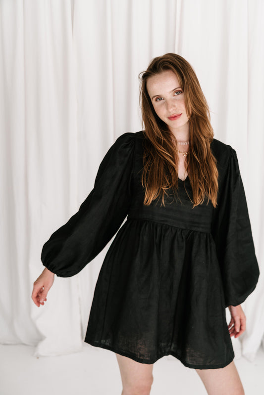 statement long puff sleeve black linen dress with v front, flattering shape, elastic cuffs flowy fit ties at back with adjustable straps short dress high quality linen