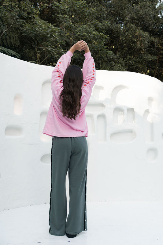 womens wide leg full length relaxed fit pant in a grey terry cotton fabric with a black drawstring and silver heart shape push studs down each leg wide leg fit to the ankle