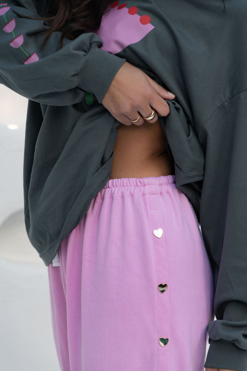 womens wide leg full length relaxed fit pant in a pink terry cotton fabric with a white drawstring and gold heart shape push studs down each leg wide leg fit to the ankle