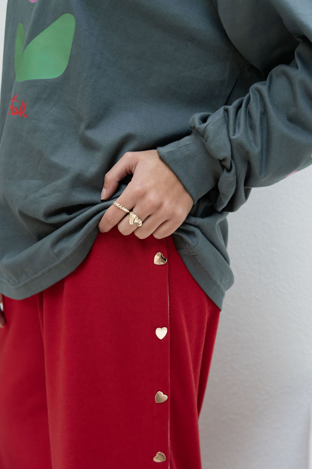 womens wide leg full length relaxed fit pant in a red terry cotton fabric with a pink drawstring and gold heart shape push studs down each leg wide leg fit to the ankle