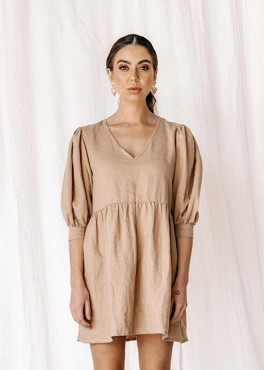 womens v neck smock made from 100% highest quality linen. A flattering cut with an adjustable back tie. Puffy 3/4 sleeves & a drop waist. Comfortable & classy allowing you to go effortlessly from day to night.