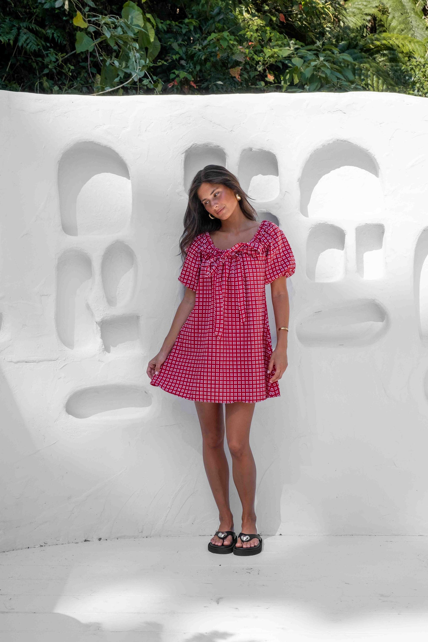 a line smock dress with a drawstring neckline and statement tie at the front puffy short sleeves in a beautiful red gingham linen cotton fabric