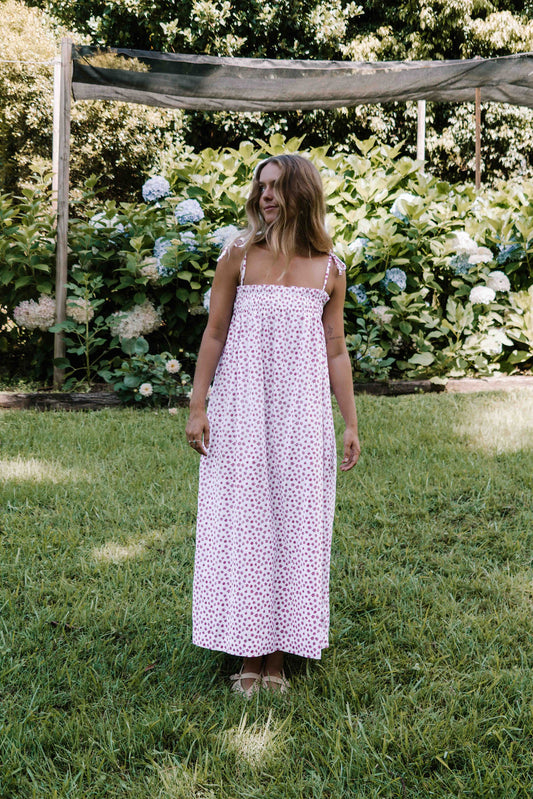 womens slip on maxi dress pink magenta flower floral print on a white background rouched tie up top strappy shoulders very flattering fit versatile wear through the seasons