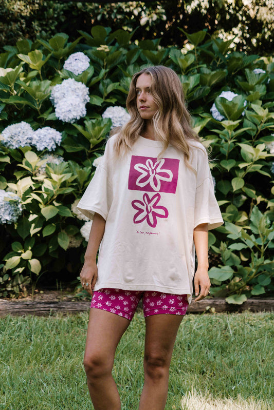 womens tshirt oversized fit with bold graphic hand painted logo in pink magenta on a  cream organic cotton tshirt comfortable boxxy fit soft fabric