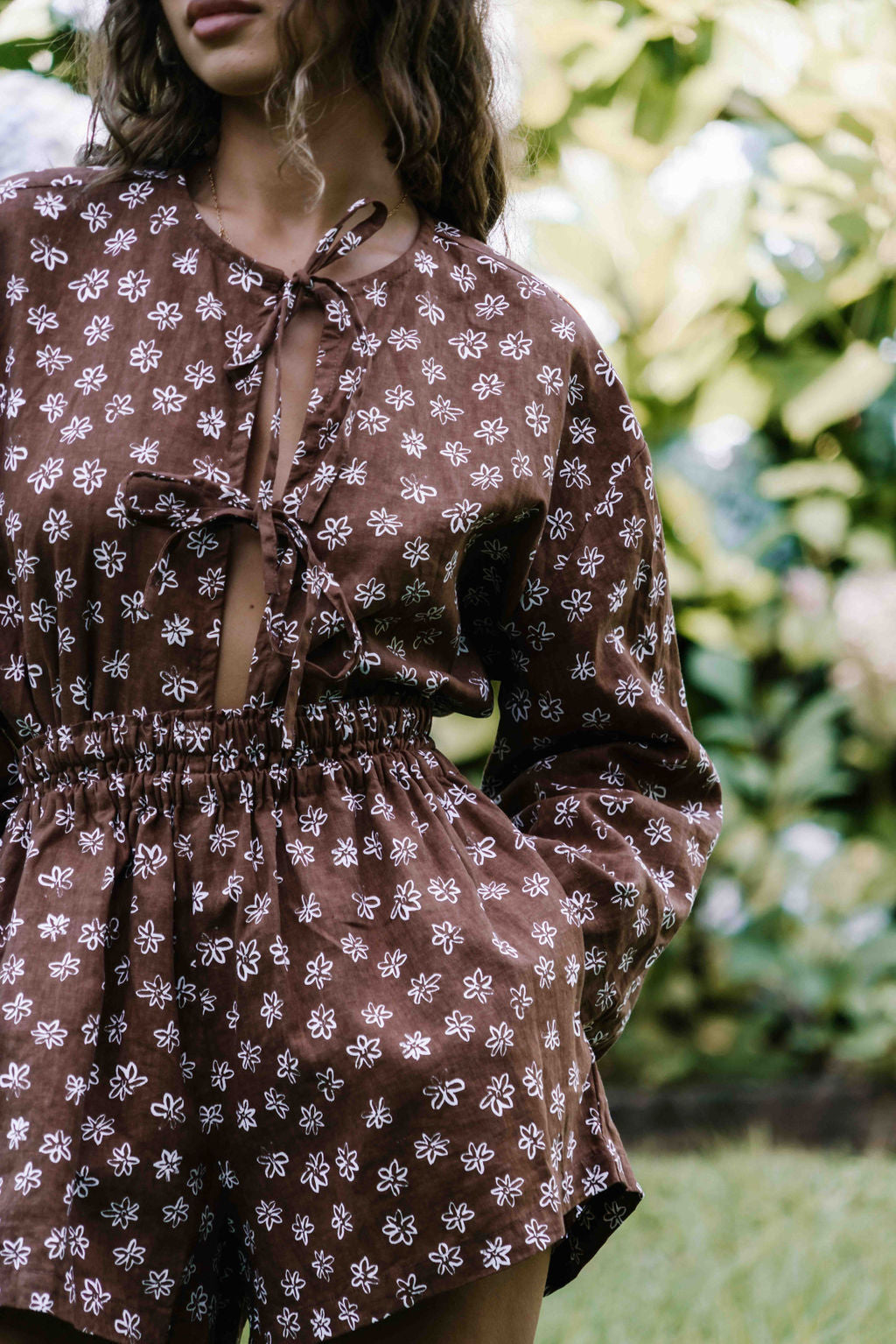 womens shorts with elastic waist and pockets, high waisted but can be worn lower. White HAND PAINTED flower print in dark mocha brown colour.