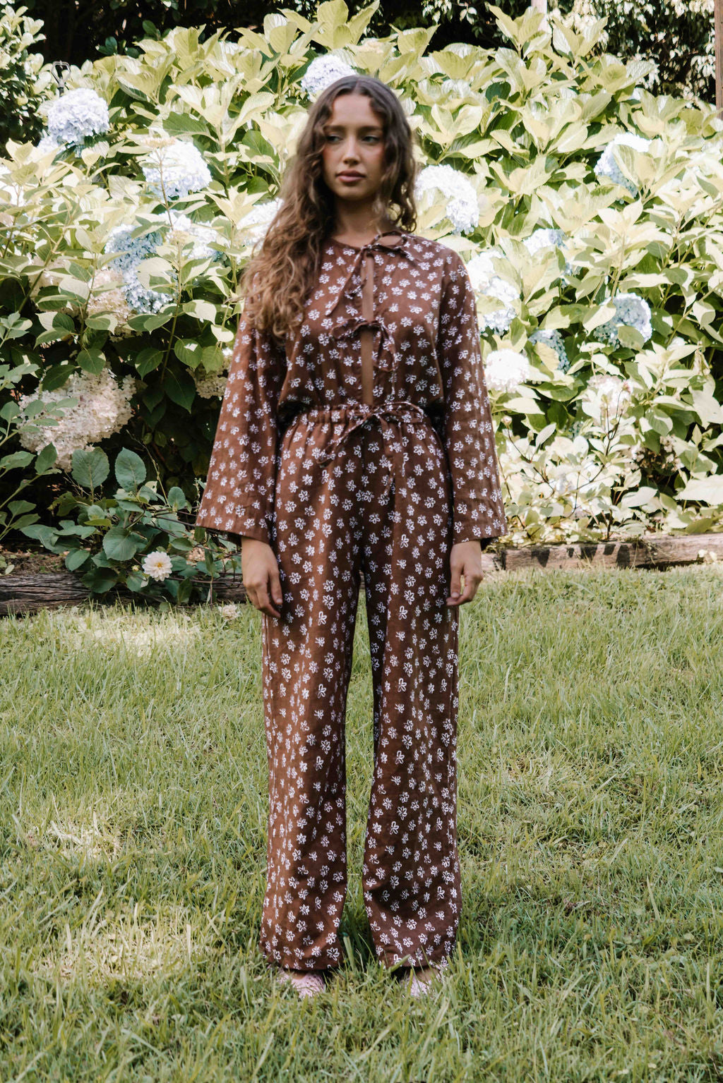 womens wide leg full length relaxed fit pant in a dark mocha brown cotton linen fabric with a hand painted flower print in white elastic waist with drawstring wide leg fit to the ankles