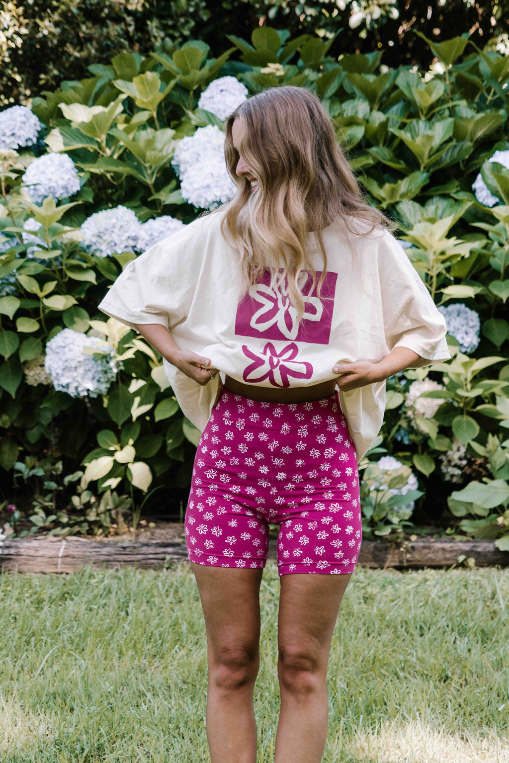 womens bike pants active leisure wear stretch cotton with a small flower floral print in white on a bright magenta pink
