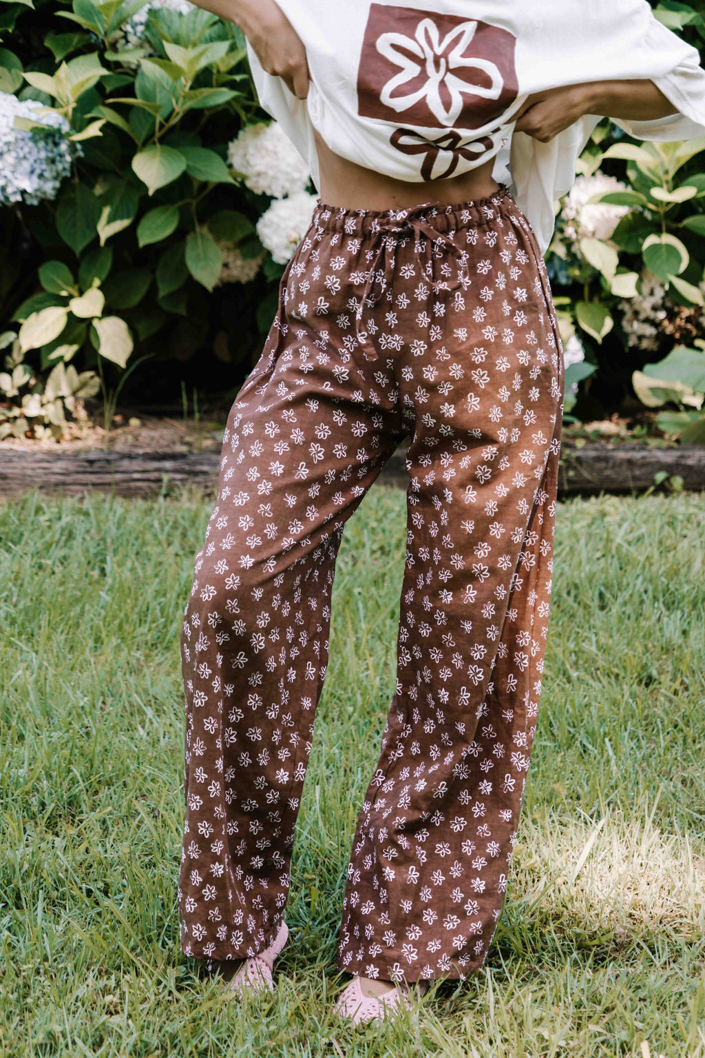 womens wide leg full length relaxed fit pant in a dark mocha brown cotton linen fabric with a hand painted flower print in white elastic waist with drawstring wide leg fit to the ankles