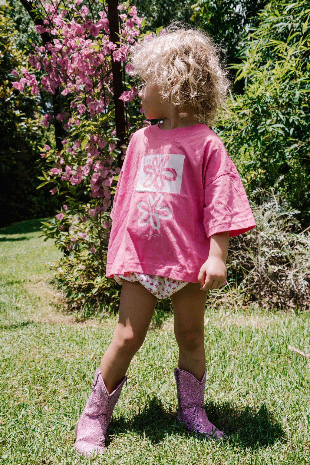 kids tshirt oversized fit with bold graphic hand painted logo in white on a  lolly bright pink organic cotton tshirt comfortable boxxy fit soft fabric