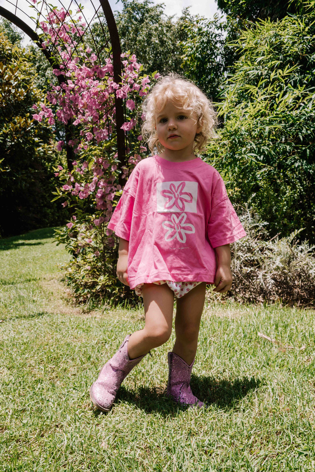 kids tshirt oversized fit with bold graphic hand painted logo in white on a  lolly bright pink organic cotton tshirt comfortable boxxy fit soft fabric