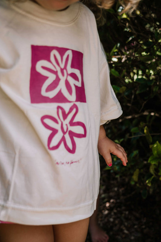 kids tshirt oversized fit with bold graphic hand painted logo in pink magenta on a  cream organic cotton tshirt comfortable boxxy fit soft fabric