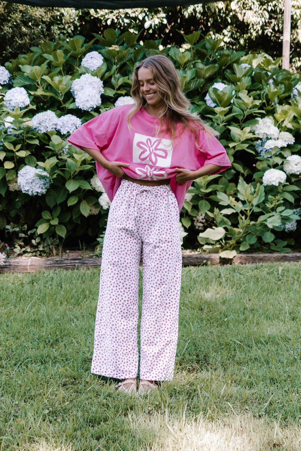 womens wide leg full length relaxed fit pant in a floral flower print in magenta pink on a white background elastic waist with drawstring