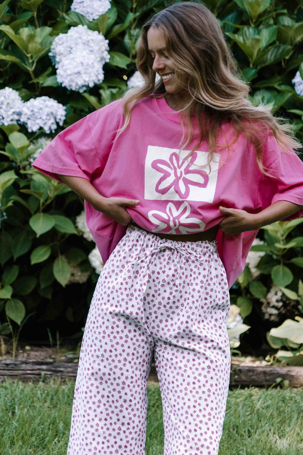 womens tshirt oversized fit with bold graphic hand painted logo in white on a  lolly bright pink organic cotton tshirt comfortable boxxy fit soft fabric