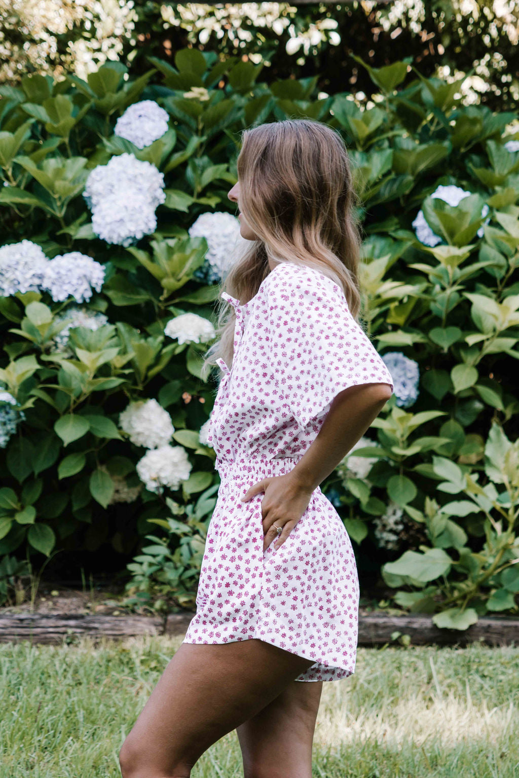 womens shorts with elastic waist and pockets, high waisted but can be worn lower small flower floral print in poink magenta colour on white background