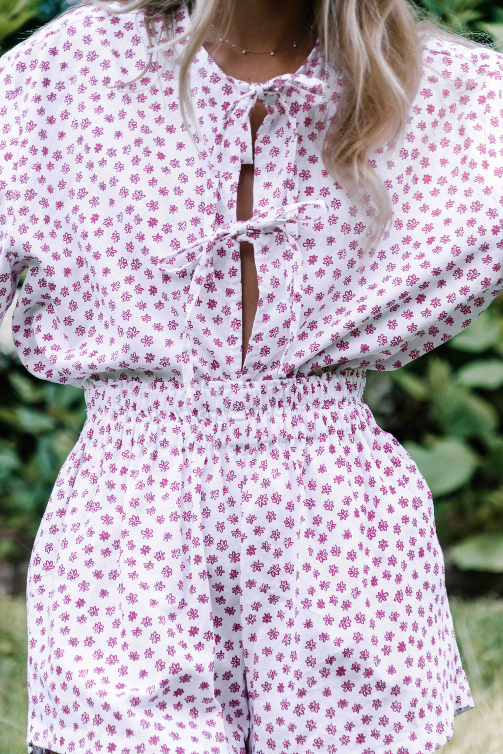 womens shorts with elastic waist and pockets, high waisted but can be worn lower small flower floral print in poink magenta colour on white background