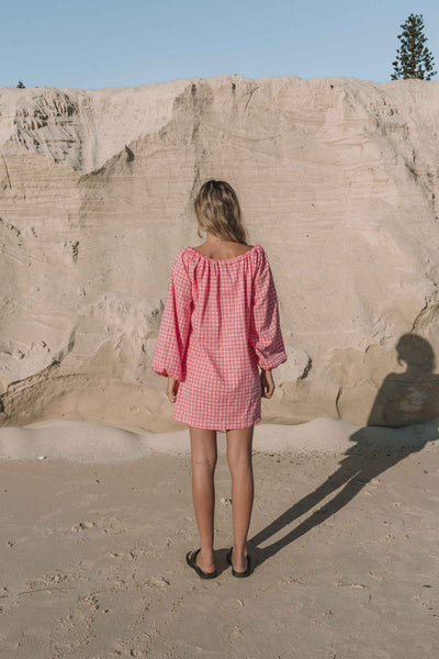 pink gingham mini dress with a statement balloon long sleeve, rounded neckline with adjustable bow tie at the front