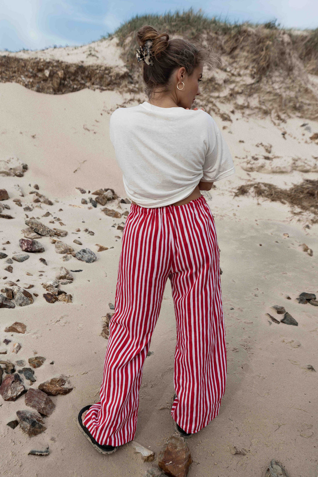 womens wide leg full length relaxed fit pant in a vibrant red and pink  cotton linen fabric with a hand painted striped print  elastic waist with drawstring wide leg fit to the ankles