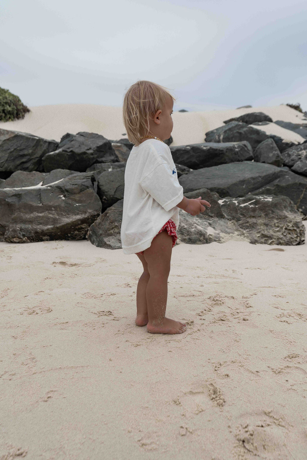 Children's t-shirt made from soft 100% orgaic cotton in a off white oversized fit with blue ‘ON HOLIDAY’ graphic. The shirt has a relaxed, comfy fit.