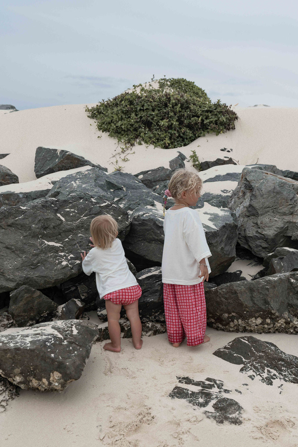 Children's t-shirt made from soft 100% orgaic cotton in a off white oversized fit with red ‘ON HOLIDAY’ graphic. The shirt has a relaxed, comfy fit.