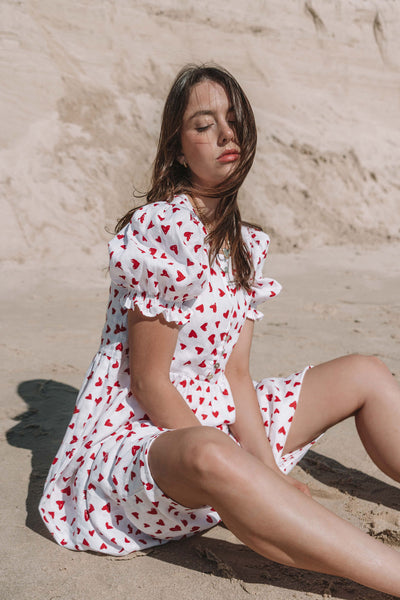 womens mini dress smock in red and white heart print with puff sleeves and adjustable back ties can be worn reversed has a button down front and is breastfeeding friendly