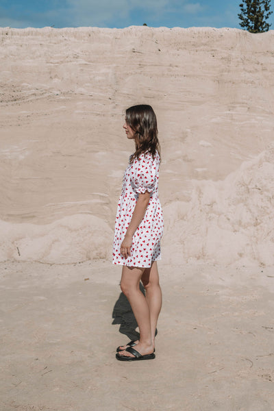 womens mini dress smock in red and white heart print with puff sleeves and adjustable back ties can be worn reversed has a button down front and is breastfeeding friendly