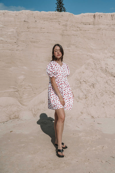 womens mini dress smock in red and white heart print with puff sleeves and adjustable back ties can be worn reversed has a button down front and is breastfeeding friendly