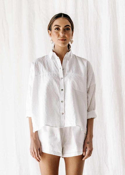 The new everyday blouse that will take you from sunrise to sunset. The new everyday blouse that will take you from sunrise to sunset, the Capri Shirt is so comfortable you’ll never want to take it off. Button up white textured blouse / shirt, short sleeve super soft. Long sleeve, shell button detail 100% high-quality cotton Beautiful textured dot fabric Pockets Split detail on sides Oversized fit Made from the highest quality cotton fabric, that is cool & breathable to wear ETHICALLY MADE IN INDONESIA
